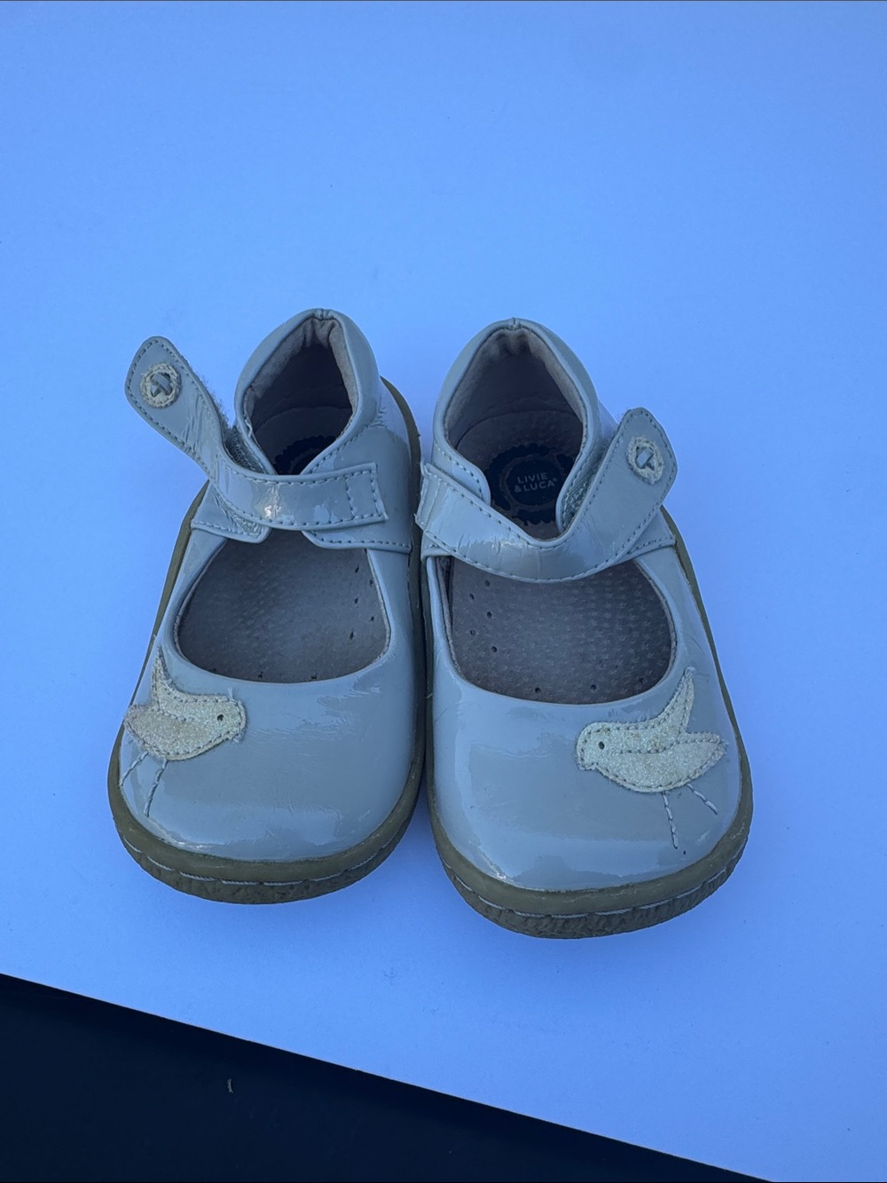 Livie & Luca Girls Patent Mary Janes in Light Beige with Bird Accent
